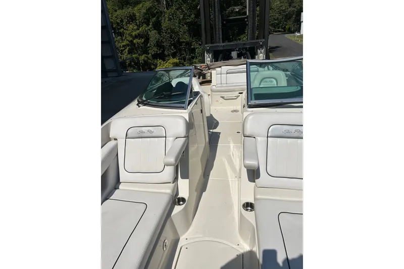 Slide: The Image of 2010 Sea Ray 260 Sundeck interior with white seating and open deck layout. - 20