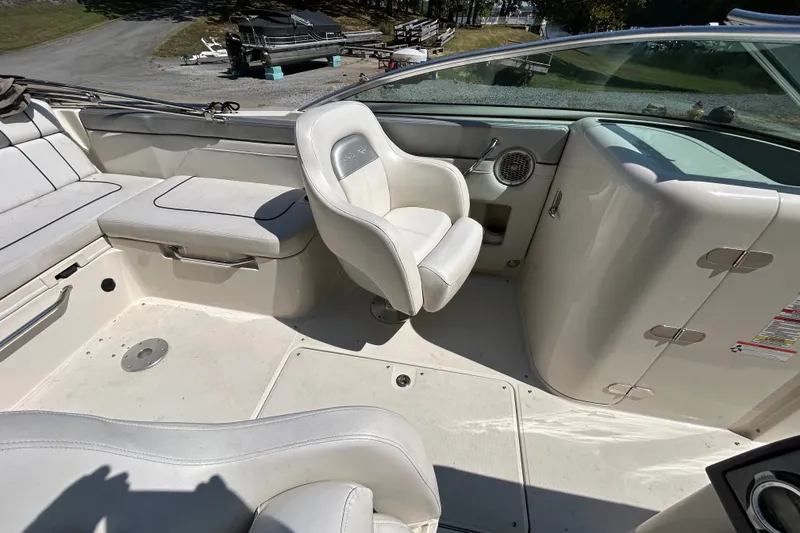 Slide: The Image of 2010 Sea Ray 260 Sundeck interior with white seating and helm area. - 15