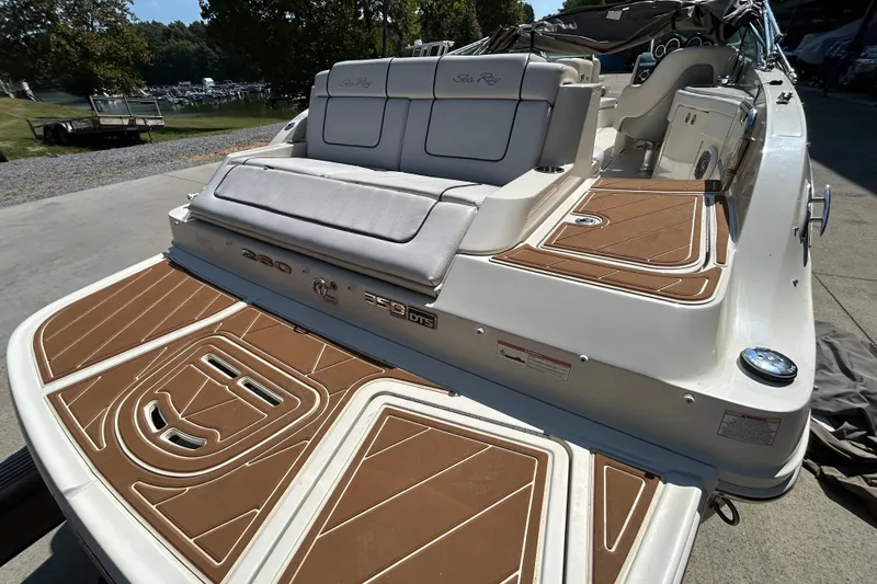 Slide: The Image of 2010 Sea Ray 260 Sundeck boat with cushioned seating and teak-style decking. - 32
