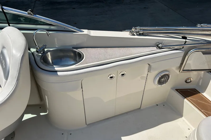 Slide: The Image of Interior view of a 2010 Sea Ray 260 Sundeck featuring a built-in sink and seating area. - 16