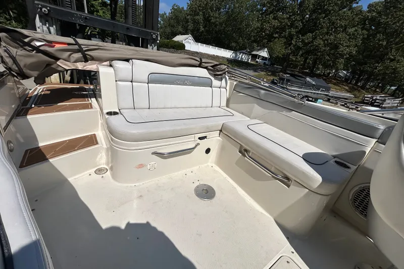 Slide: The Image of 2010 Sea Ray 260 Sundeck interior with white seating and storage compartments. - 17