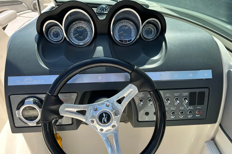 Slide: The Image of Dashboard of a 2010 Sea Ray 260 Sundeck boat with steering wheel and gauges. - 29