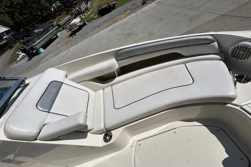 Slide: The Image of 2010 Sea Ray 260 Sundeck boat interior with white seating and speaker. - 23