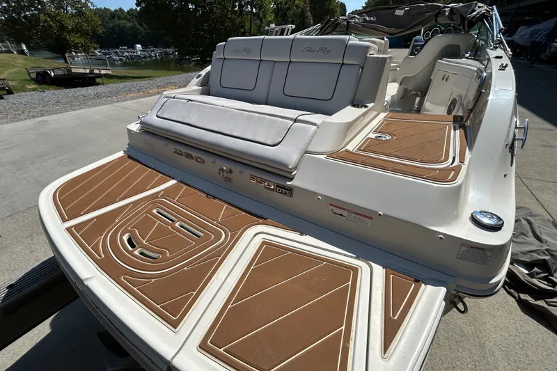 Slide: The Image of 2010 Sea Ray 260 Sundeck boat with cushioned seating and teak-style decking. - 34