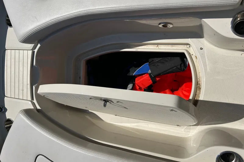 Slide: The Image of Storage compartment on a 2010 Sea Ray 260 Sundeck with life jackets inside. - 26