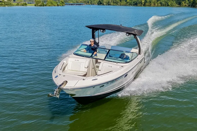 Slide: The Image of 2019 Sea Ray SLX 280 cruising on a serene lake with lush green surroundings. - 11