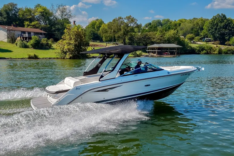 The Image of 2019 Sea Ray SLX 280 cruising on a scenic lake with lush greenery. - 0