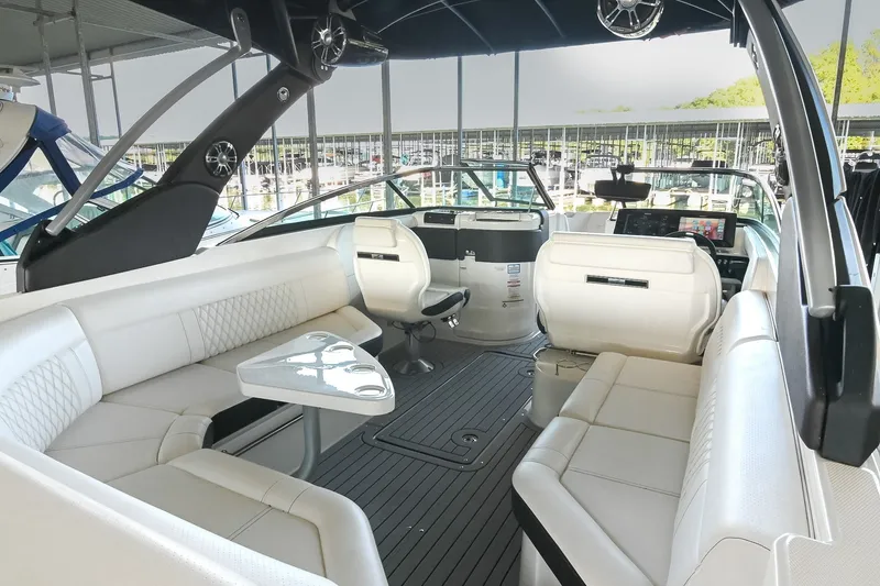 Slide: The Image of 2019 Sea Ray SLX 280 boat interior with luxurious white seating and modern dashboard. - 15