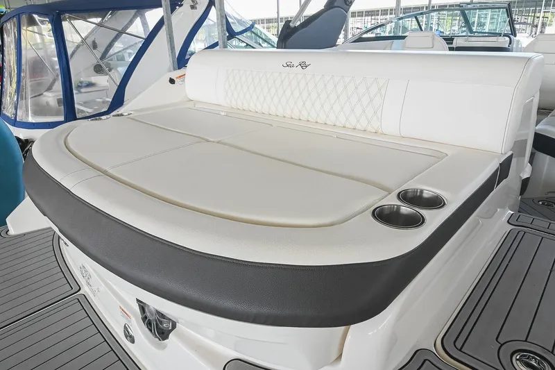 Slide: The Image of 2019 Sea Ray SLX 280 boat interior with cushioned seating and cup holders. - 13