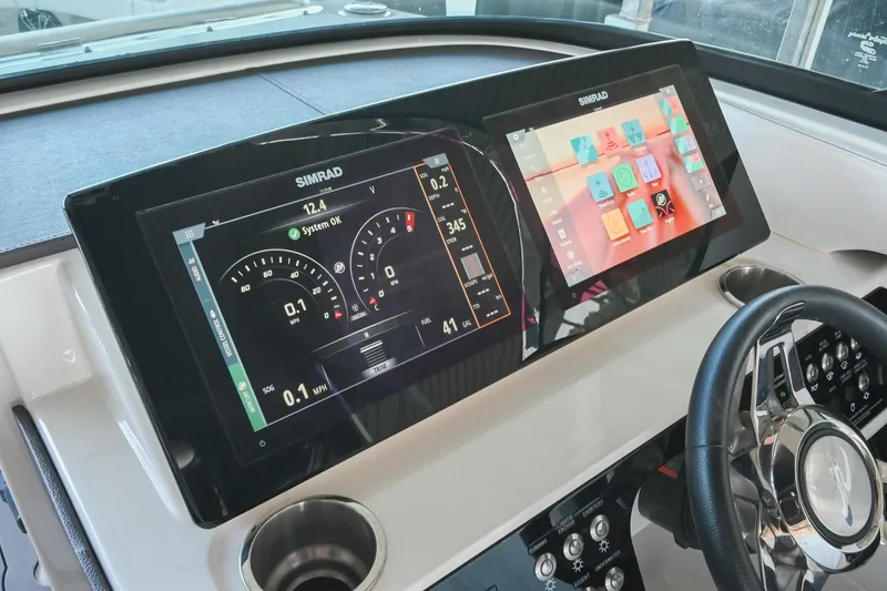 Slide: The Image of Dashboard of 2019 Sea Ray SLX 280 boat with dual Simrad displays and steering wheel. - 27