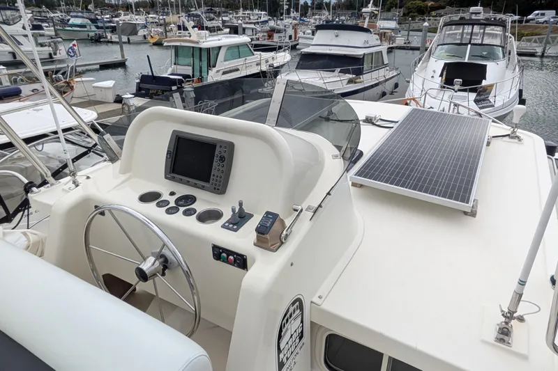 Slide: The Image of 2003 Nordic Tug 37 boat helm with solar panel, docked in marina. - 6