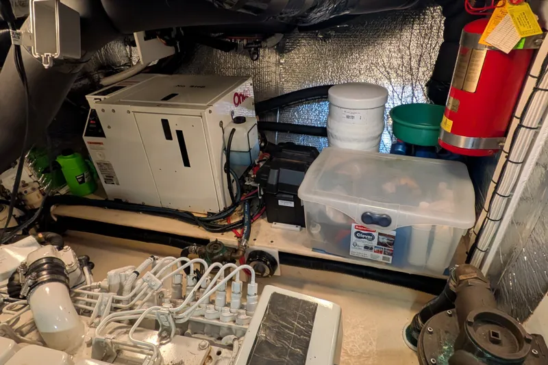 Slide: The Image of Engine room of a 2003 Nordic Tug 37 with equipment and storage containers. - 46