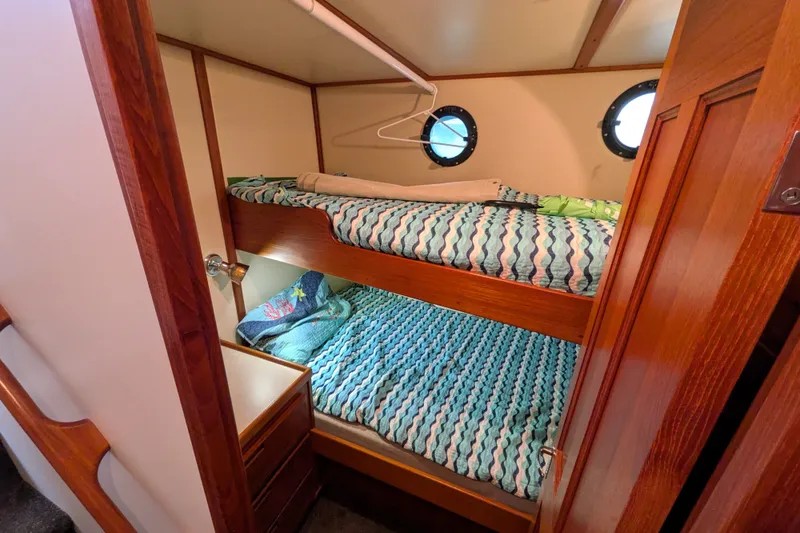 Slide: The Image of Cozy cabin with bunk beds in a 2003 Nordic Tug 37 boat interior. - 34