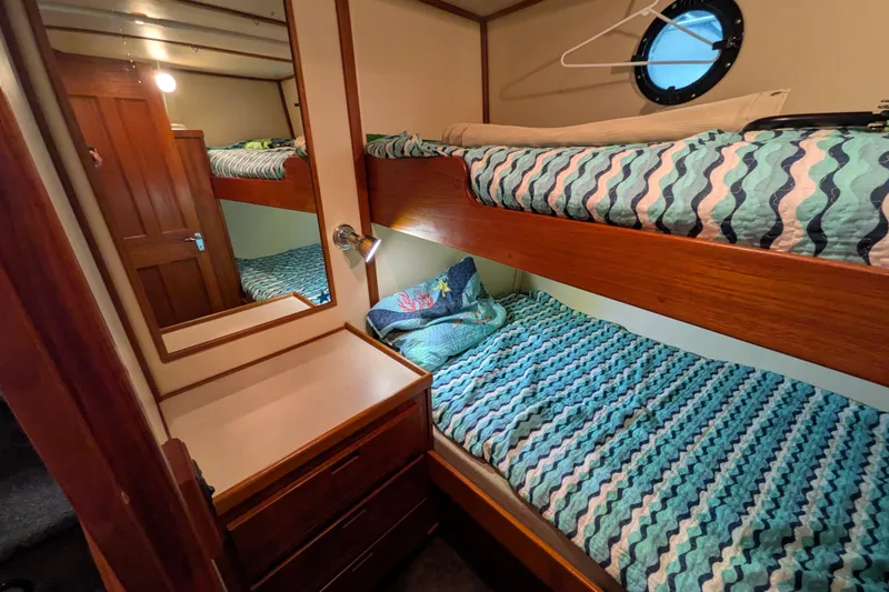 Slide: The Image of Cozy cabin with bunk beds in a 2003 Nordic Tug 37 boat interior. - 36
