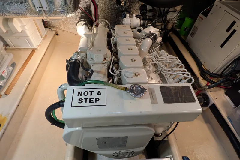 Slide: The Image of Engine room of a 2003 Nordic Tug 37 with a "Not a Step" warning sign. - 48