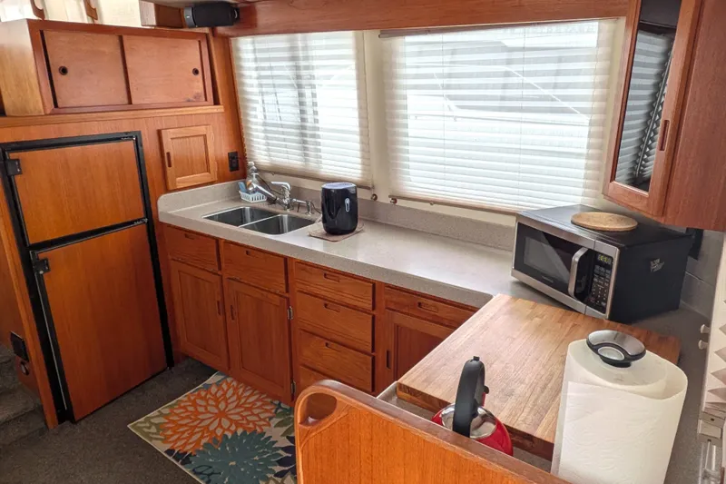 Slide: The Image of Cozy kitchen in 2003 Nordic Tug 37 with wooden cabinets and modern appliances. - 15