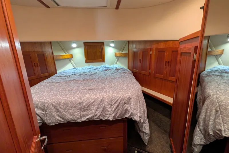 Slide: The Image of Cozy bedroom in 2003 Nordic Tug 37 with wood cabinetry and soft lighting. - 41