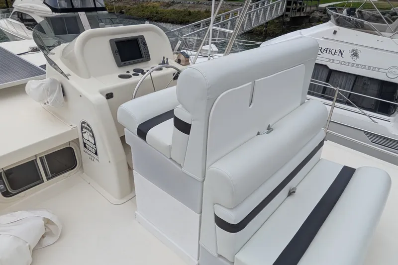 Slide: The Image of 2003 Nordic Tug 37 boat helm with white seating and navigation equipment. - 8