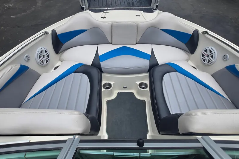 Slide: The Image of 2008 MasterCraft X-35 boat interior with blue and gray seating, featuring built-in speakers. - 12