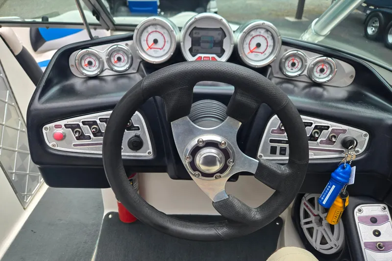 Slide: The Image of Dashboard of a 2008 MasterCraft X-35 boat with steering wheel and gauges. - 11