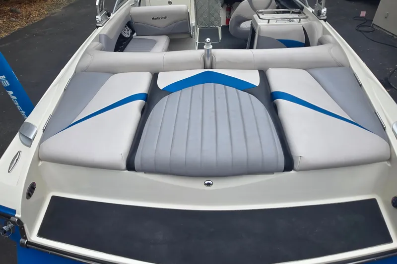 Slide: The Image of 2008 MasterCraft X-35 boat interior with gray and blue seating, showcasing luxury design. - 18