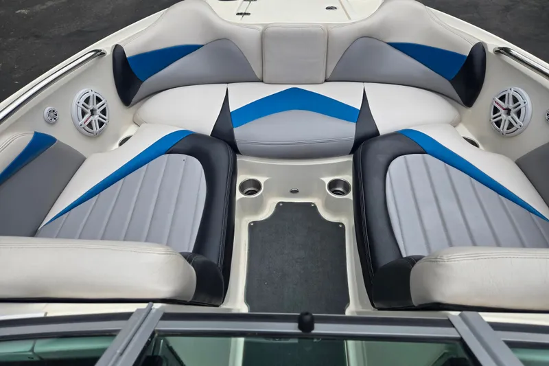 Slide: The Image of 2008 MasterCraft X-35 boat interior with blue and gray seating, featuring built-in speakers. - 6