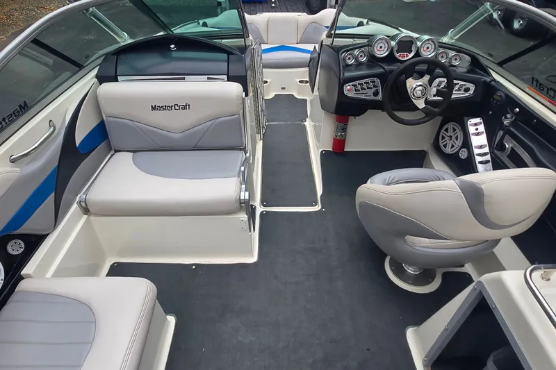 Slide: The Image of 2008 MasterCraft X-35 boat interior with gray seating and modern dashboard controls. - 16
