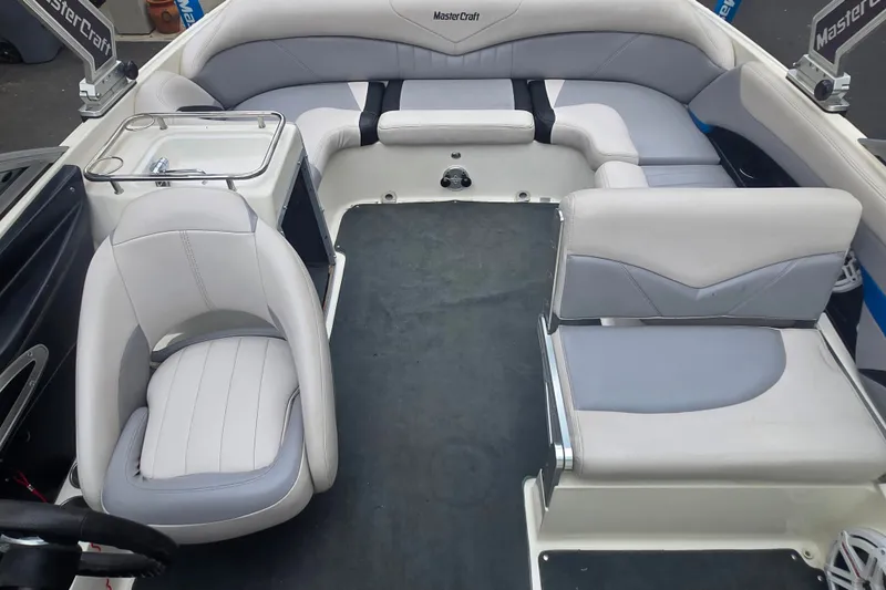 Slide: The Image of 2008 MasterCraft X-35 boat interior with white and gray seating arrangement. - 20