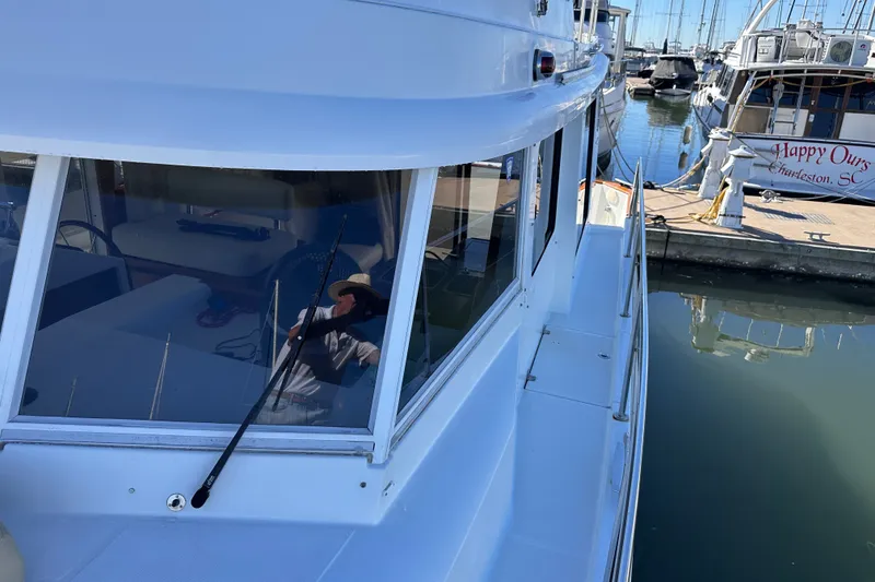 Slide: The Image of 2011 Beneteau Swift Trawler 34 docked at marina, reflecting calm waters. - 15
