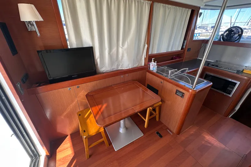 Slide: The Image of Interior of 2011 Beneteau Swift Trawler 34 with dining area and kitchenette. - 35