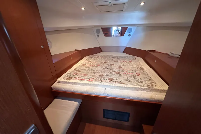 Slide: The Image of Cozy cabin interior of 2011 Beneteau Swift Trawler 34 with patterned bedding. - 64