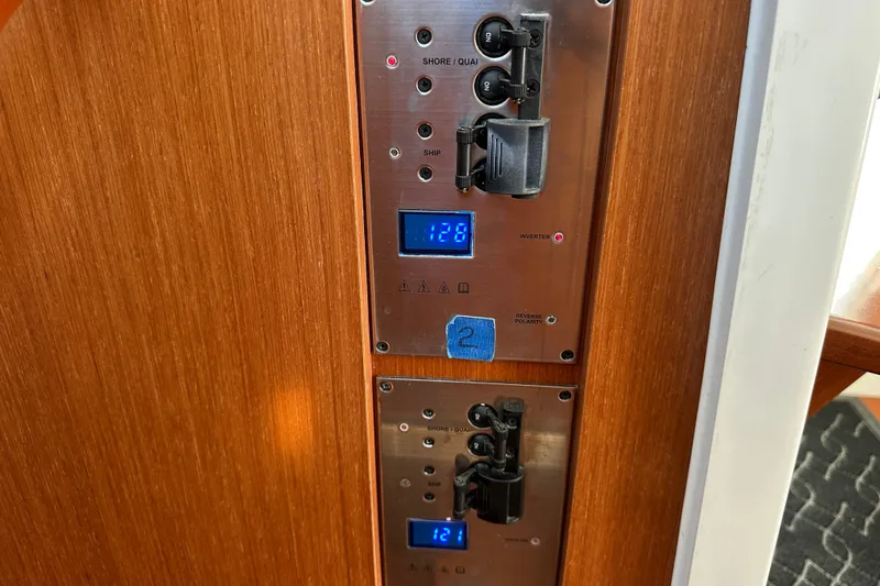 Slide: The Image of Electrical panel on 2011 Beneteau Swift Trawler 34, featuring digital displays and switches. - 58