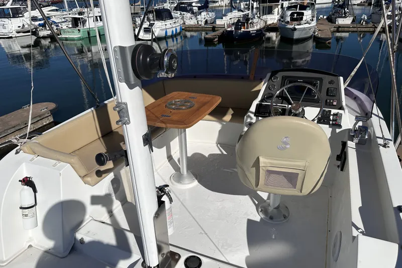 Slide: The Image of 2011 Beneteau Swift Trawler 34 cockpit with helm, seating, and marina view. - 20