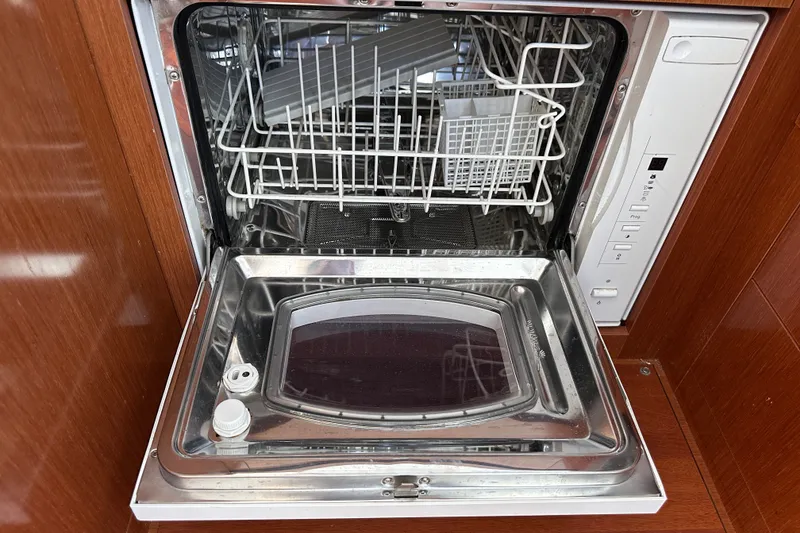 Slide: The Image of Open dishwasher inside a 2011 Beneteau Swift Trawler 34, showcasing clean interior and controls. - 41