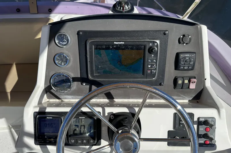 Slide: The Image of 2011 Beneteau Swift Trawler 34 helm with navigation system and controls. - 23