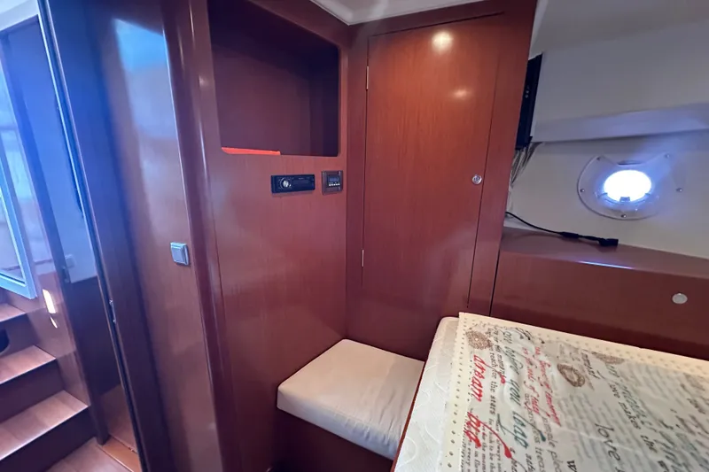 Slide: The Image of Interior of 2011 Beneteau Swift Trawler 34, featuring wood paneling and cozy seating. - 65