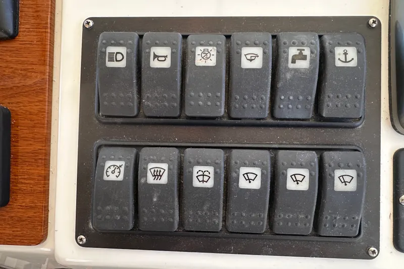 Slide: The Image of Control panel switches on a 2011 Beneteau Swift Trawler 34 boat dashboard. - 50