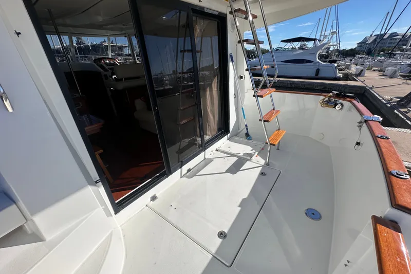 Slide: The Image of 2011 Beneteau Swift Trawler 34 cockpit with wooden accents and marina view. - 17