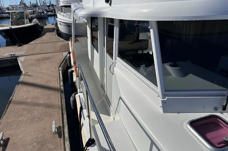 Slide: The Image of 2011 Beneteau Swift Trawler 34 docked at marina, side view. - 16