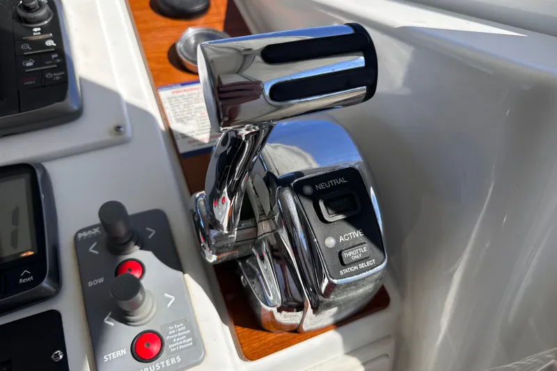 Slide: The Image of Control panel of a 2011 Beneteau Swift Trawler 34 with throttle and joystick controls. - 53