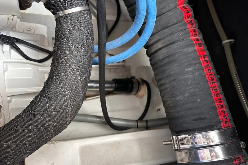 Slide: The Image of Engine compartment of a 2011 Beneteau Swift Trawler 34 with hoses and clamps. - 69