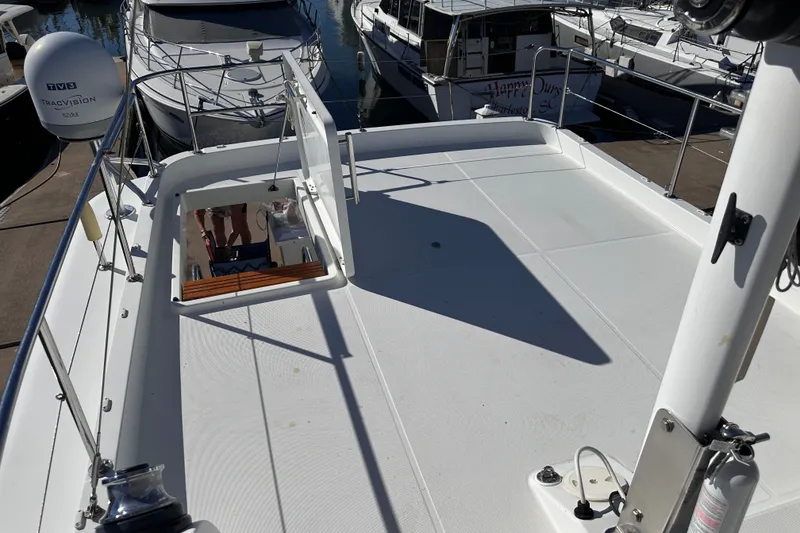 Slide: The Image of 2011 Beneteau Swift Trawler 34 flybridge with open hatch, docked at marina. - 29