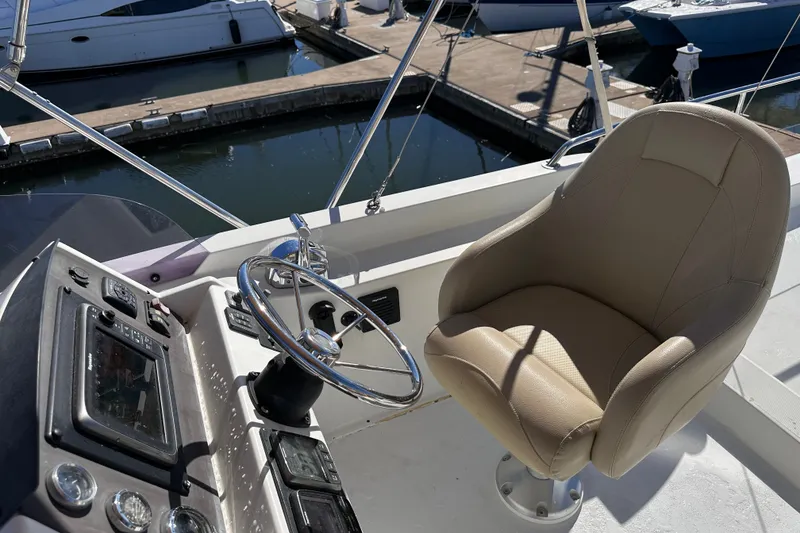 Slide: The Image of Helm station of 2011 Beneteau Swift Trawler 34 with steering wheel and captain's chair. - 21