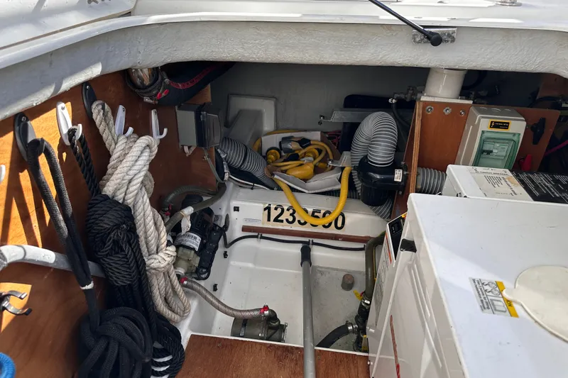 Slide: The Image of Engine compartment of a 2011 Beneteau Swift Trawler 34 with ropes and equipment. - 72