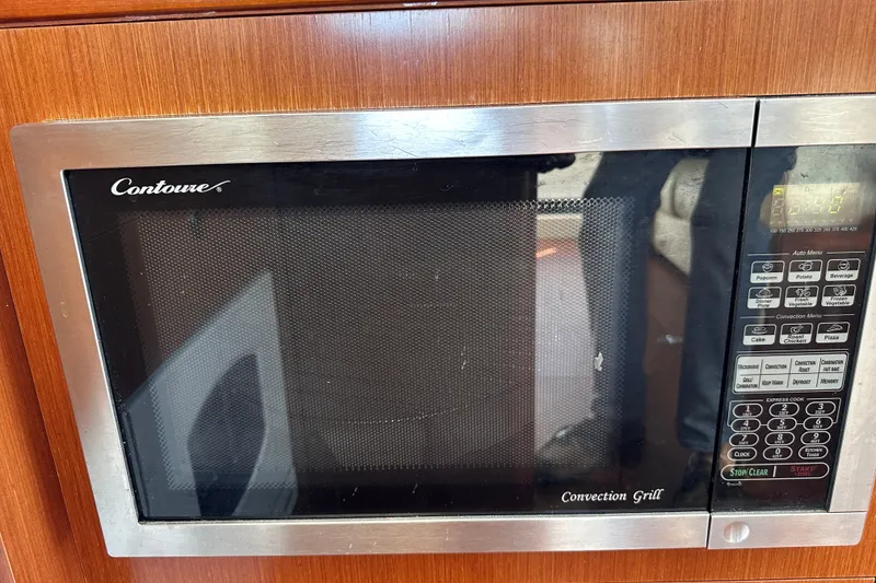 Slide: The Image of Convection grill microwave in 2011 Beneteau Swift Trawler 34 kitchen area. - 38