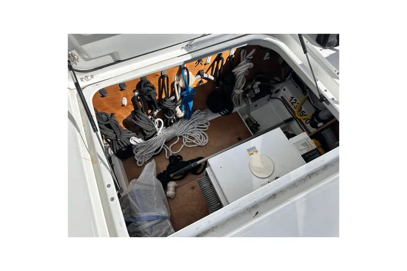 Slide: The Image of Storage compartment of a 2011 Beneteau Swift Trawler 34, featuring ropes and equipment. - 71