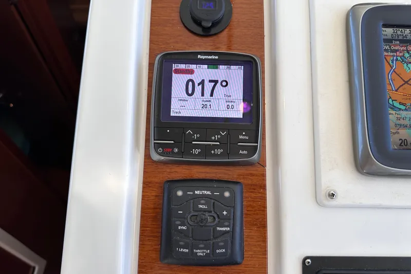 Slide: The Image of Beneteau Swift Trawler 34, 2011, navigation instruments displaying heading and controls. - 48