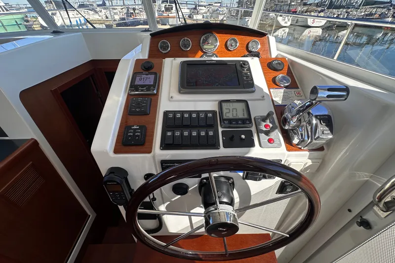 Slide: The Image of Helm of 2011 Beneteau Swift Trawler 34 with navigation controls and steering wheel. - 45
