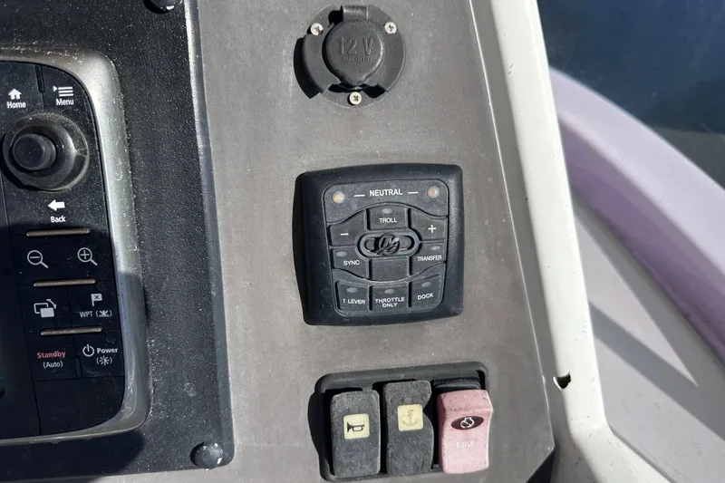 Slide: The Image of Control panel of a 2011 Beneteau Swift Trawler 34 with various buttons and switches. - 26