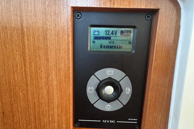 Slide: The Image of Control panel on 2011 Beneteau Swift Trawler 34 displaying voltage and amperage. - 56